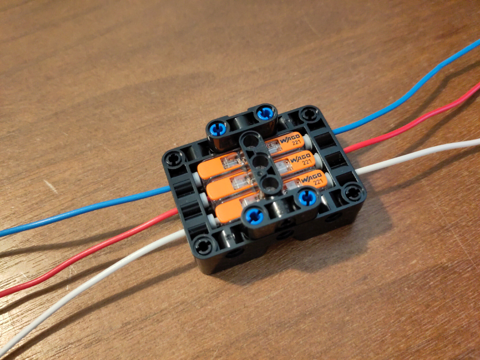 A cage for 3 wago 221-2411 connectors made from Lego technic.