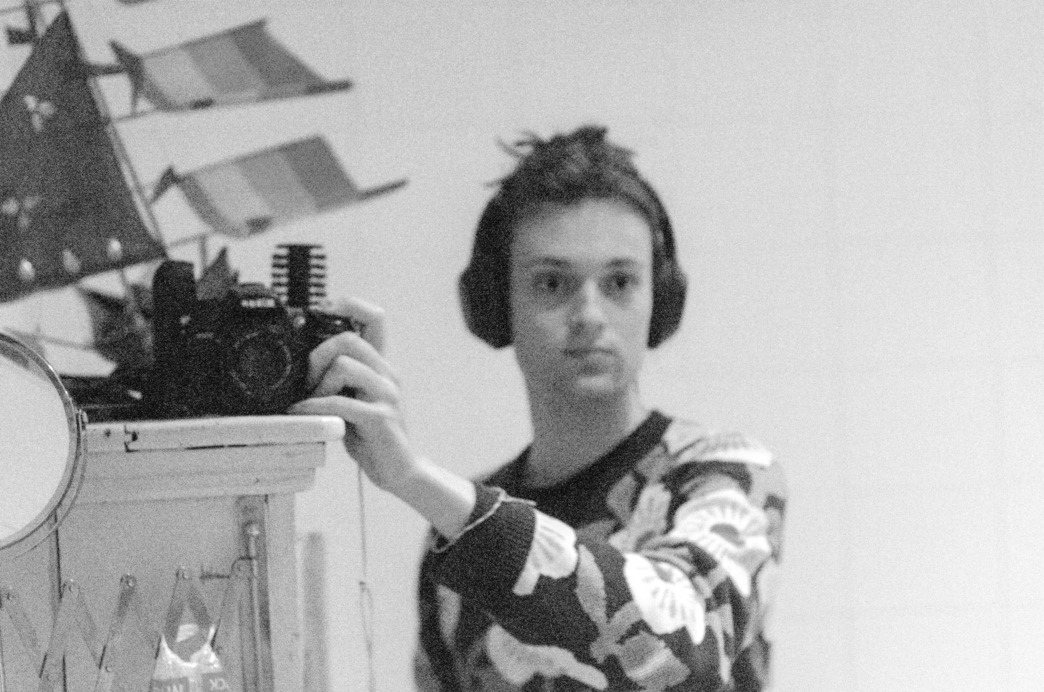 blurry bad black and white photo of me through a mirror. the noise really works in my favor for my bad photography.