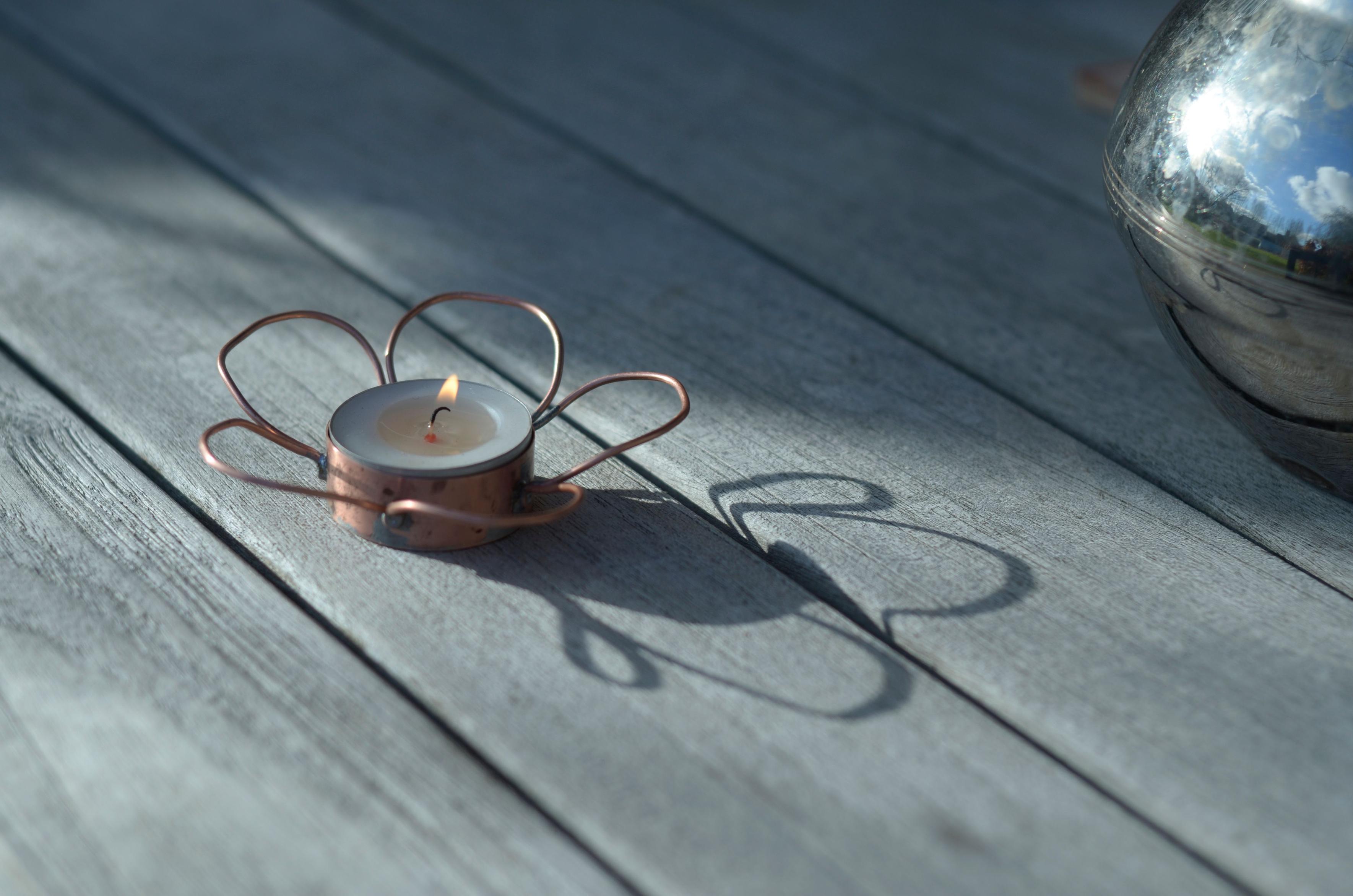 The candle holder casts a beautiful shadow in the low sunlight.