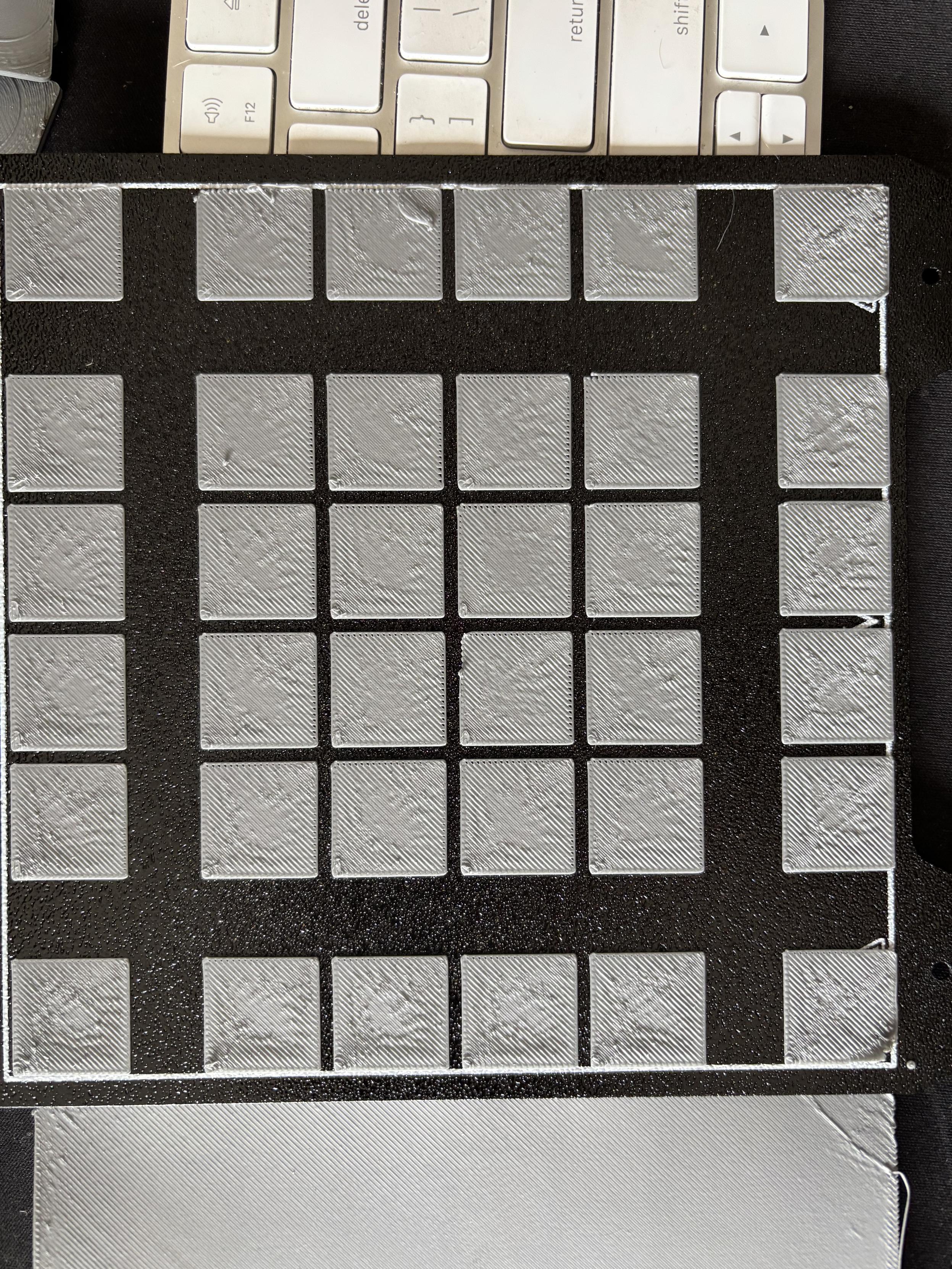 Close up of just the small squares on the Sovol zero build plate. Issues abound.