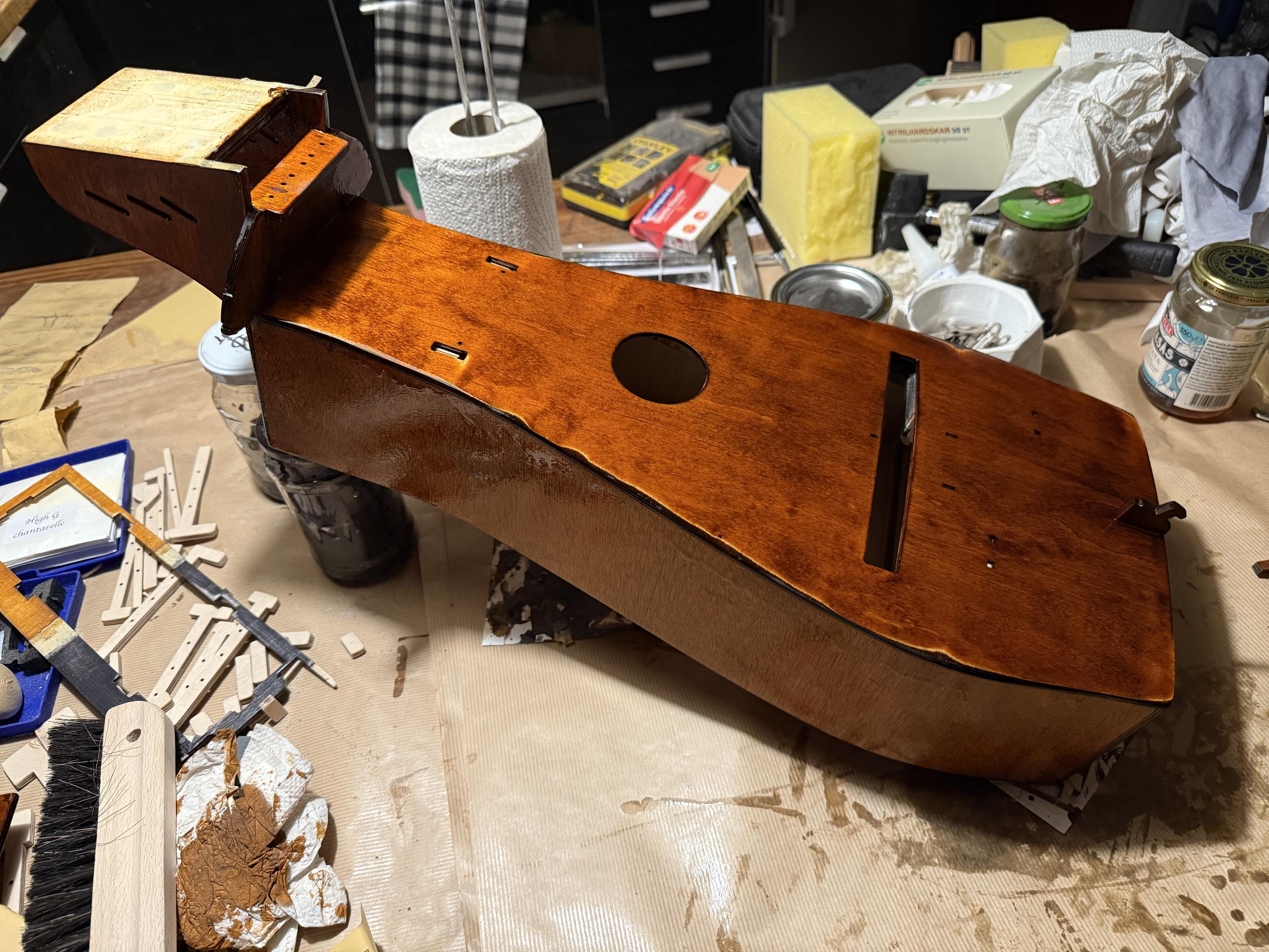 Photo of the main body of the hurdy gurdy stained brwon and with a newly added coat of polyurethane. 