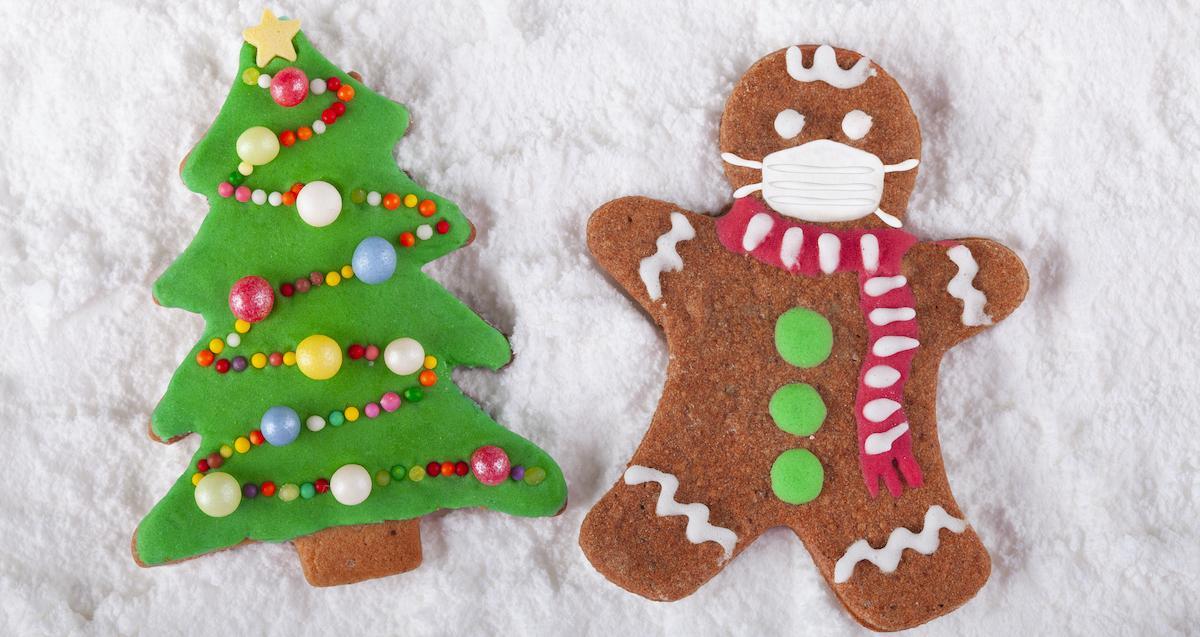 Christmas tree gingerbread cookie and a gingerbread man with a Covid mask on.