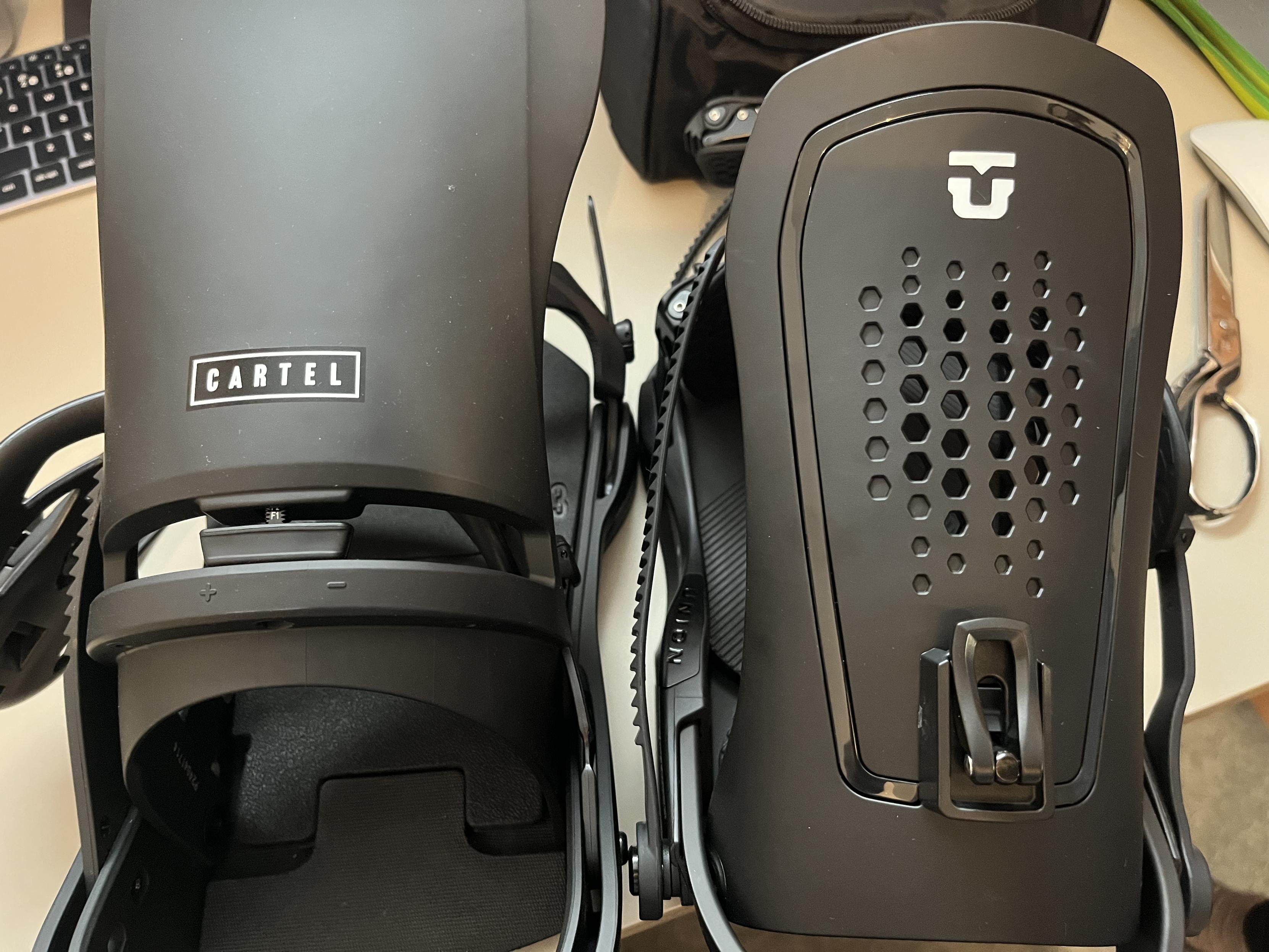 Side-by-side shot of two black snowboard bindings. Angle is from the back, with one Burton Cartel on the left and one Union Force on the right.
