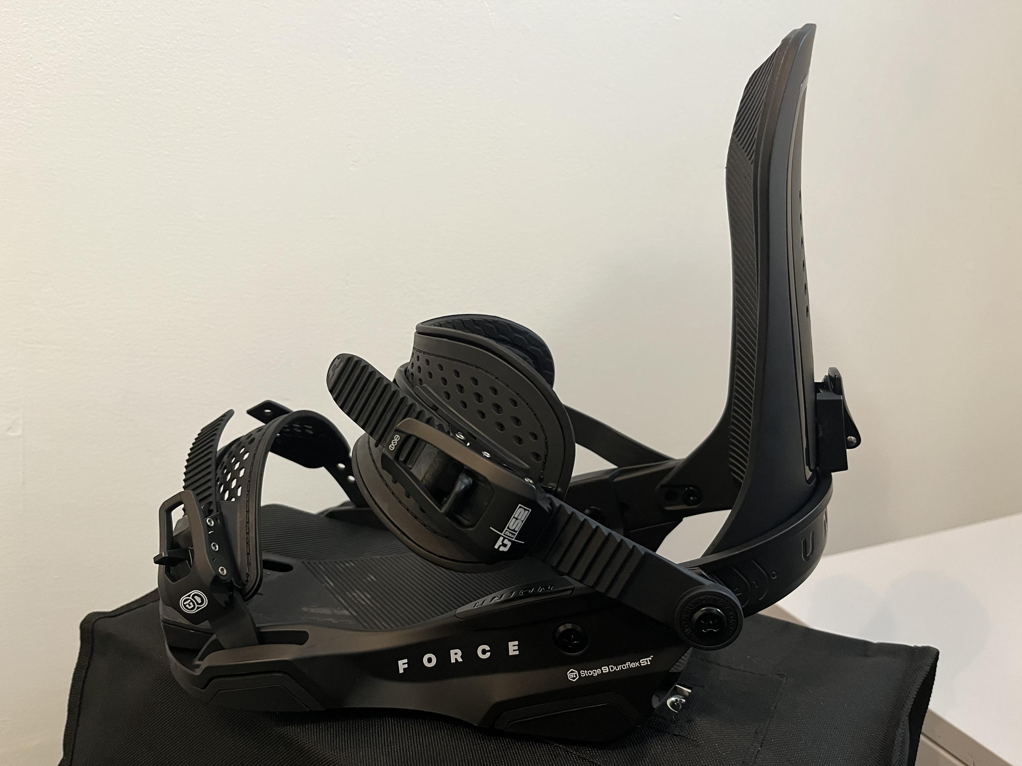 Side angle of one black Union Force snowboard binding on a white background.