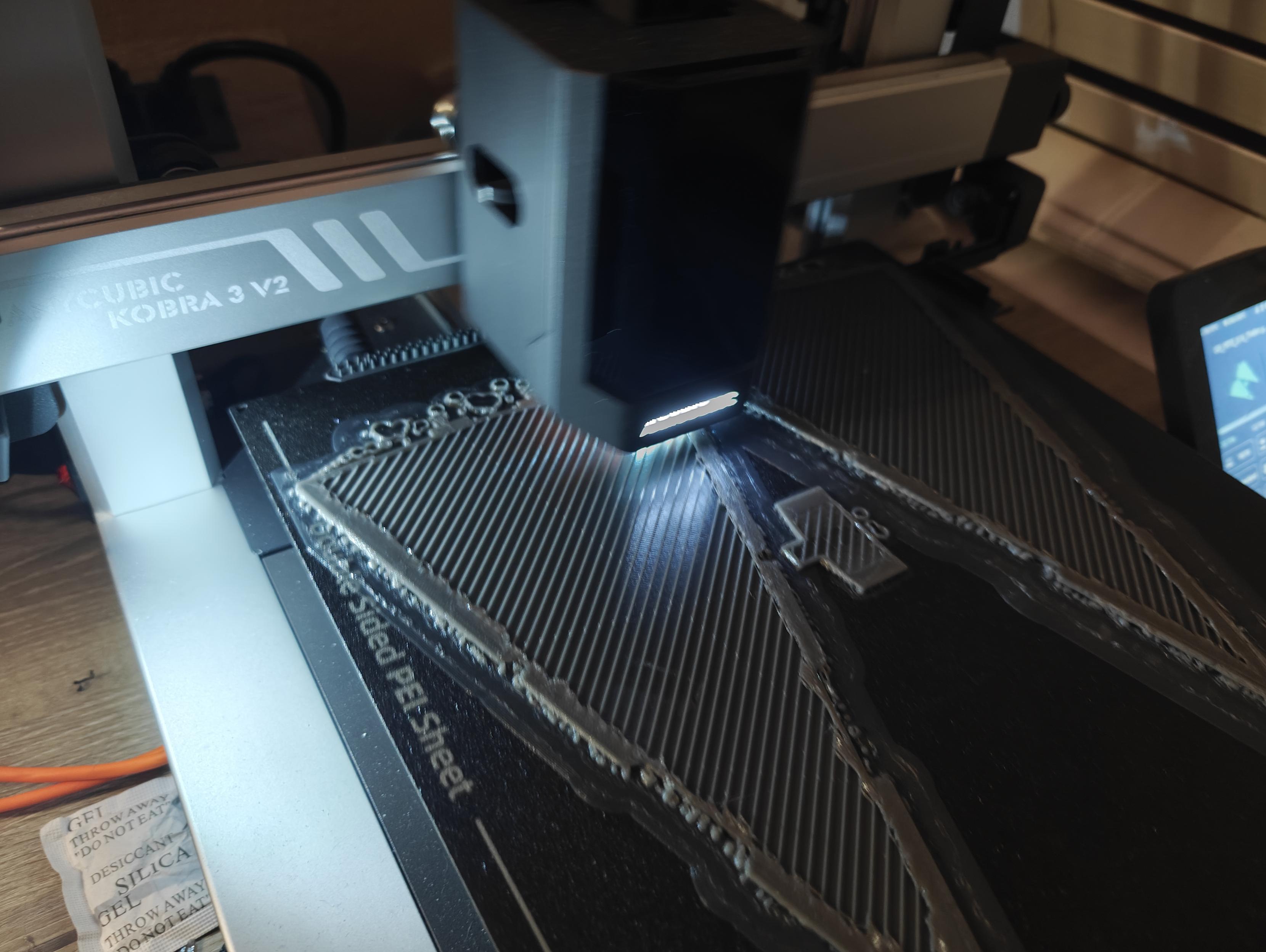 A 3d print in progress, displaying the distinctive arrow head shape of an Imperial Star Destroyer. (2 of them actually, because I cut it in half, on the z axis, to make it printable)