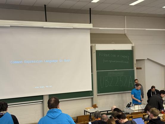 Photo of the stage with a screen saying Common Expression Language in Rust
