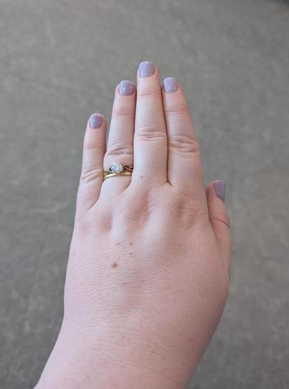 My left hand with lavender nail polish. My ring with a diamond and sapphire side stones is also visible.