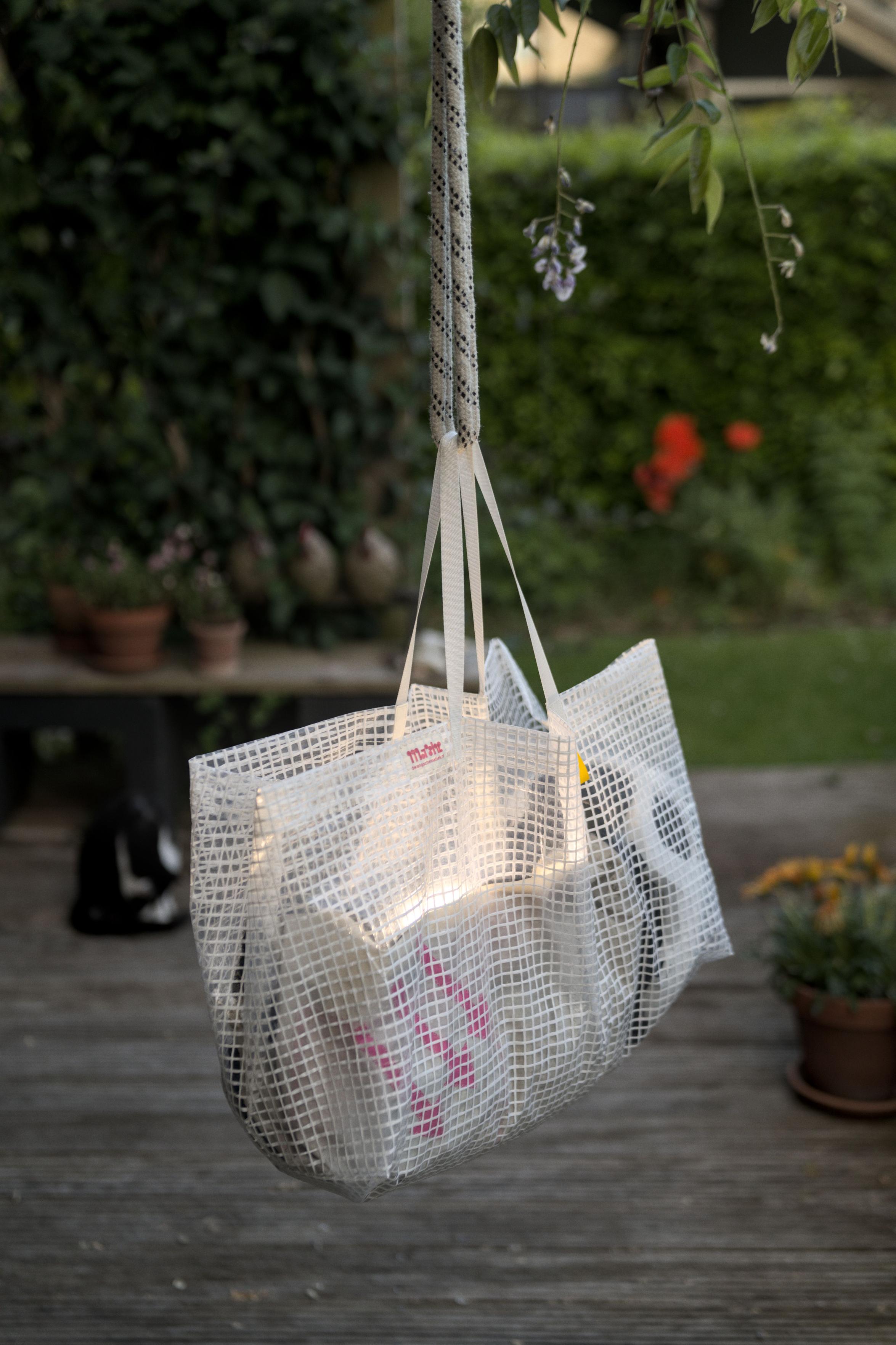 Another view of the bag hanging in the garden. You
							 can see a black and white cat in the background.