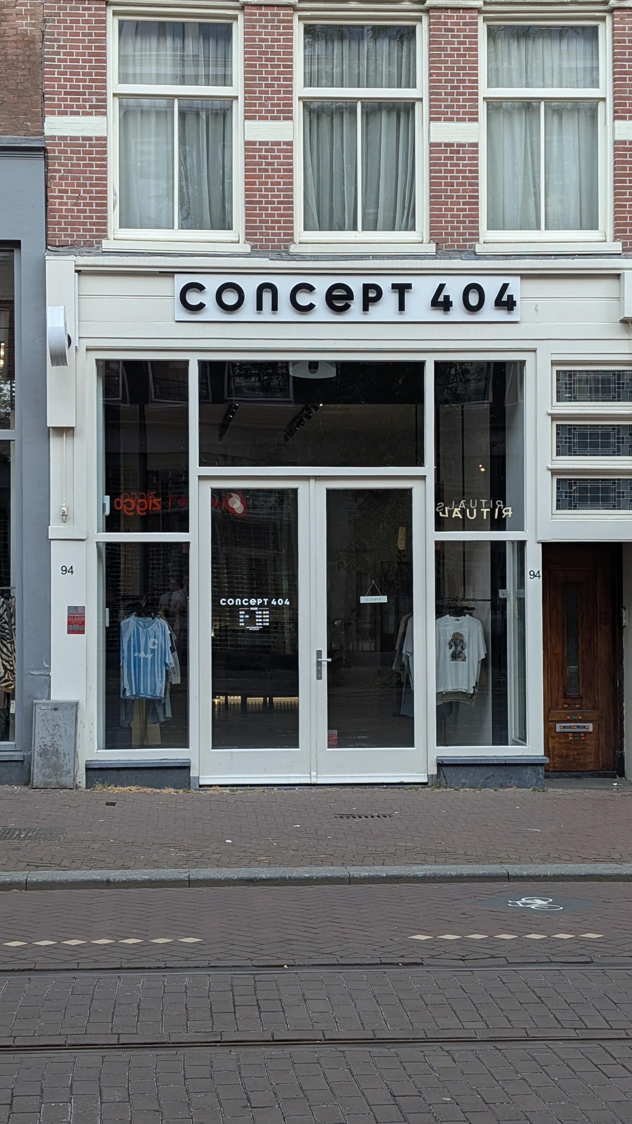 a shop called "Concept 404" with white window frames and a double door.