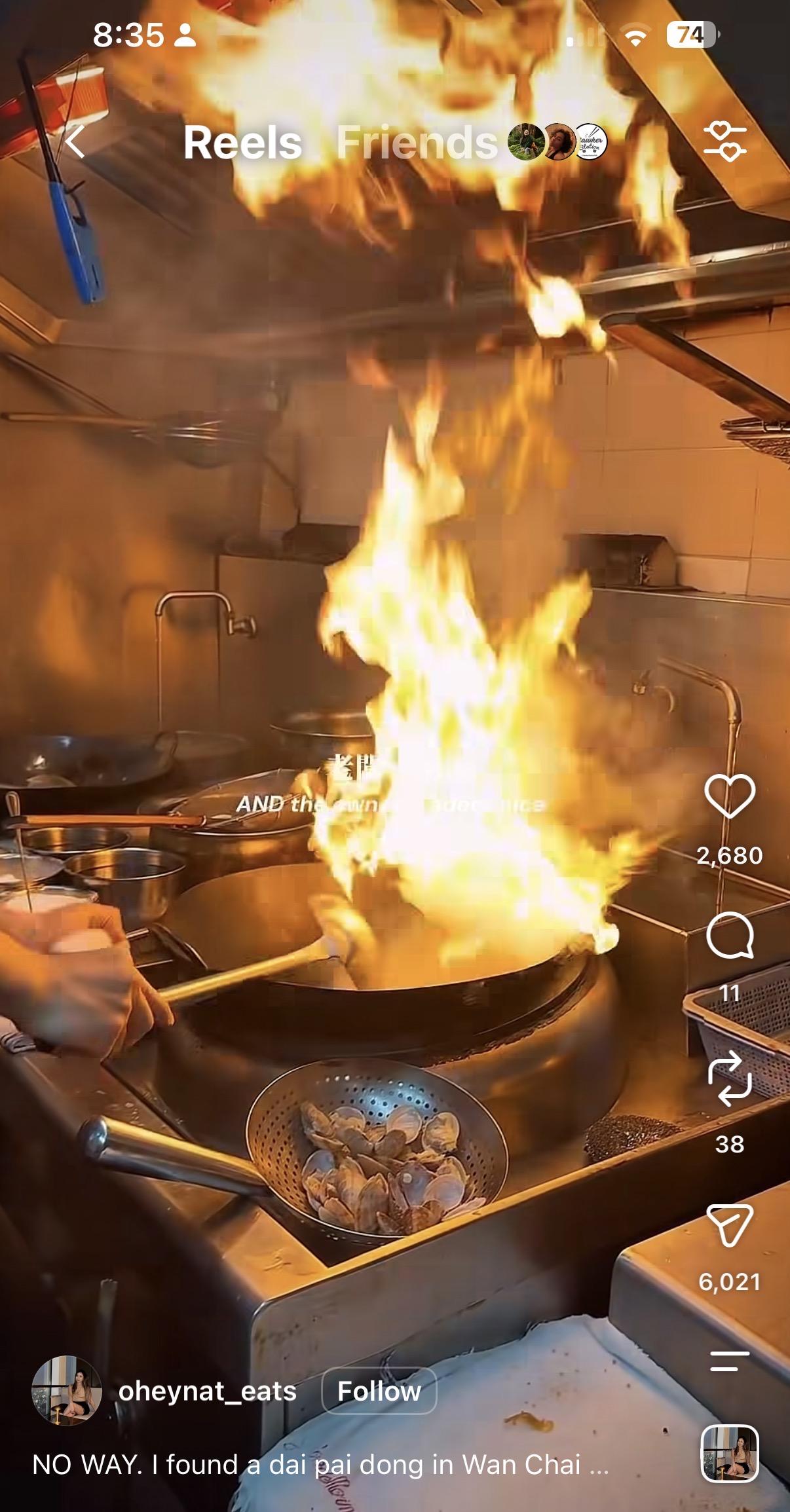 A HK dai pai dong with flames dancing a few feet in the air. Very typical of this type of cooking