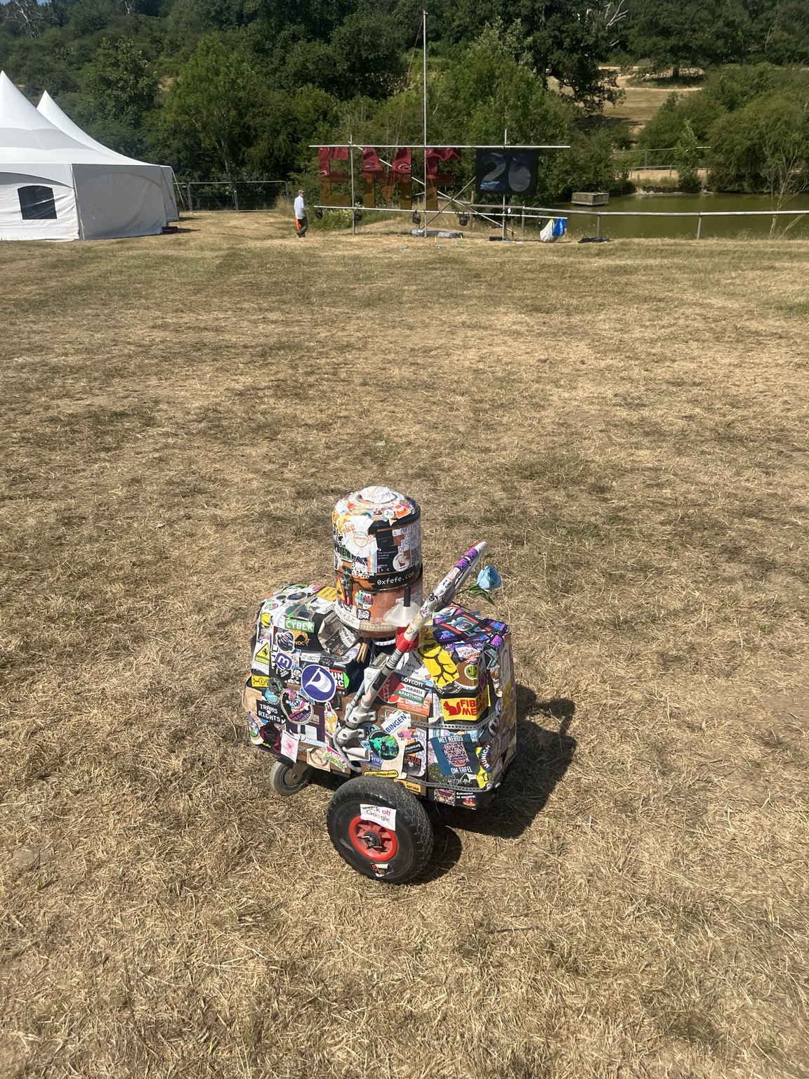 Little hand trolley thingy, covered in stickers while playing techno.