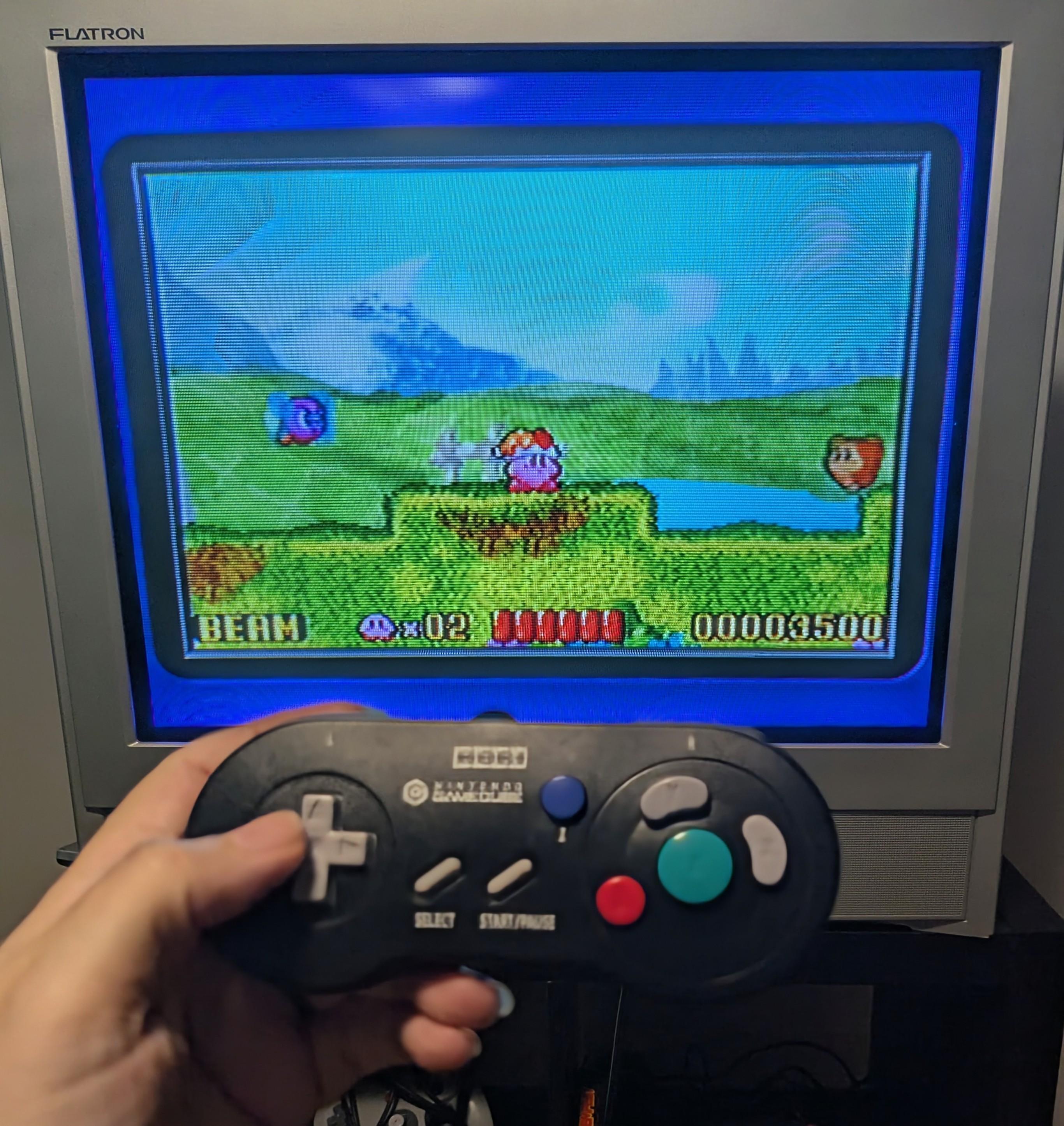 My TV playing Kirby's Nightmare in Dreamland on my CRT through the Gameboy Player, the new Hori controller held in the foreground