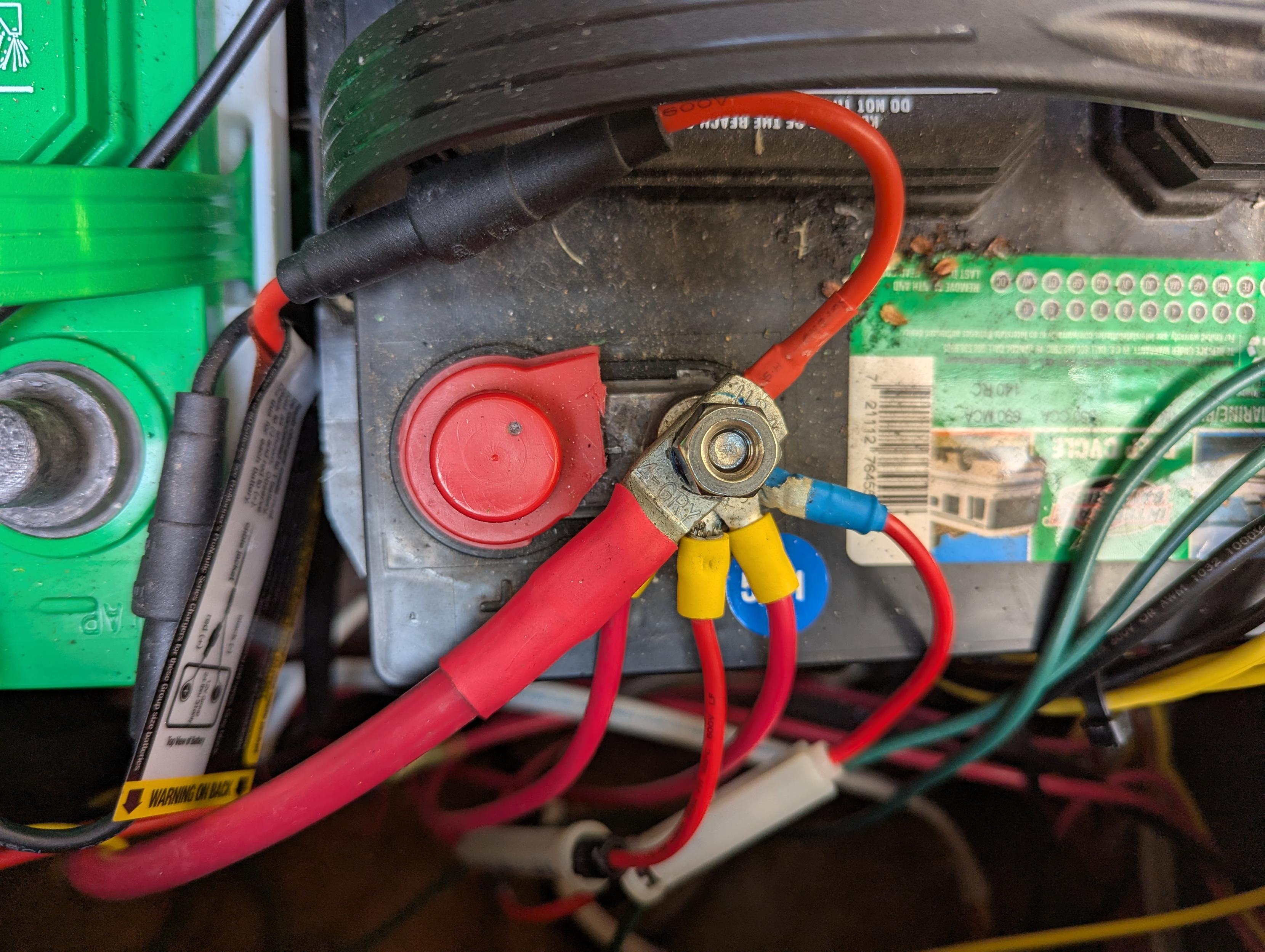 A photo of a marine battery terminal with too many lugs bolted directly to it.
