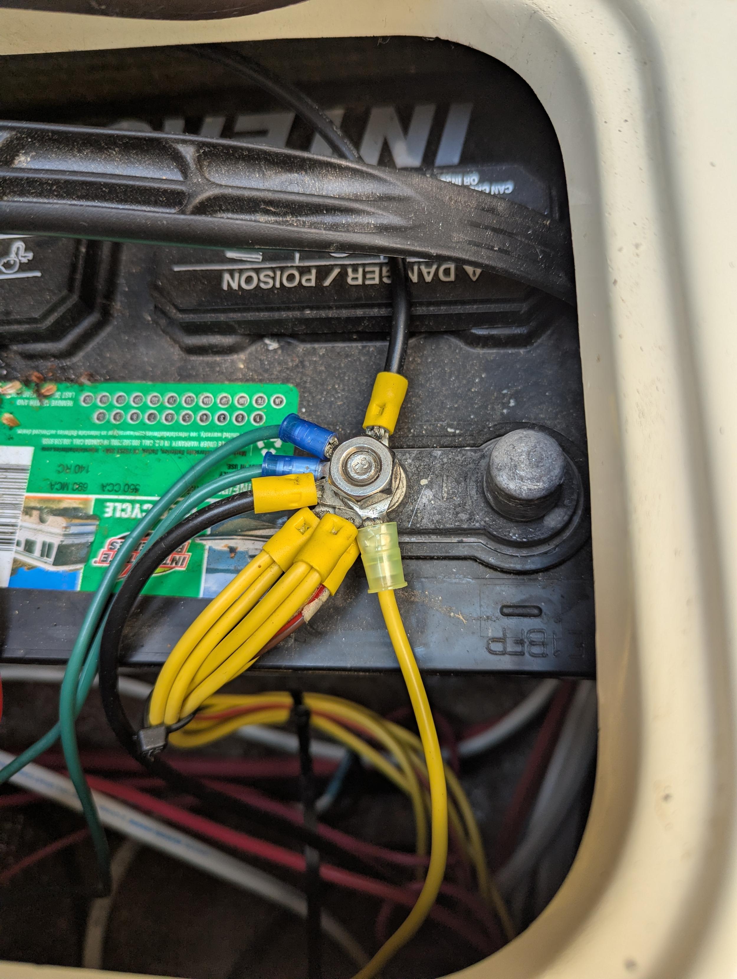 A photo of a marine battery terminal with too many lugs bolted directly to it