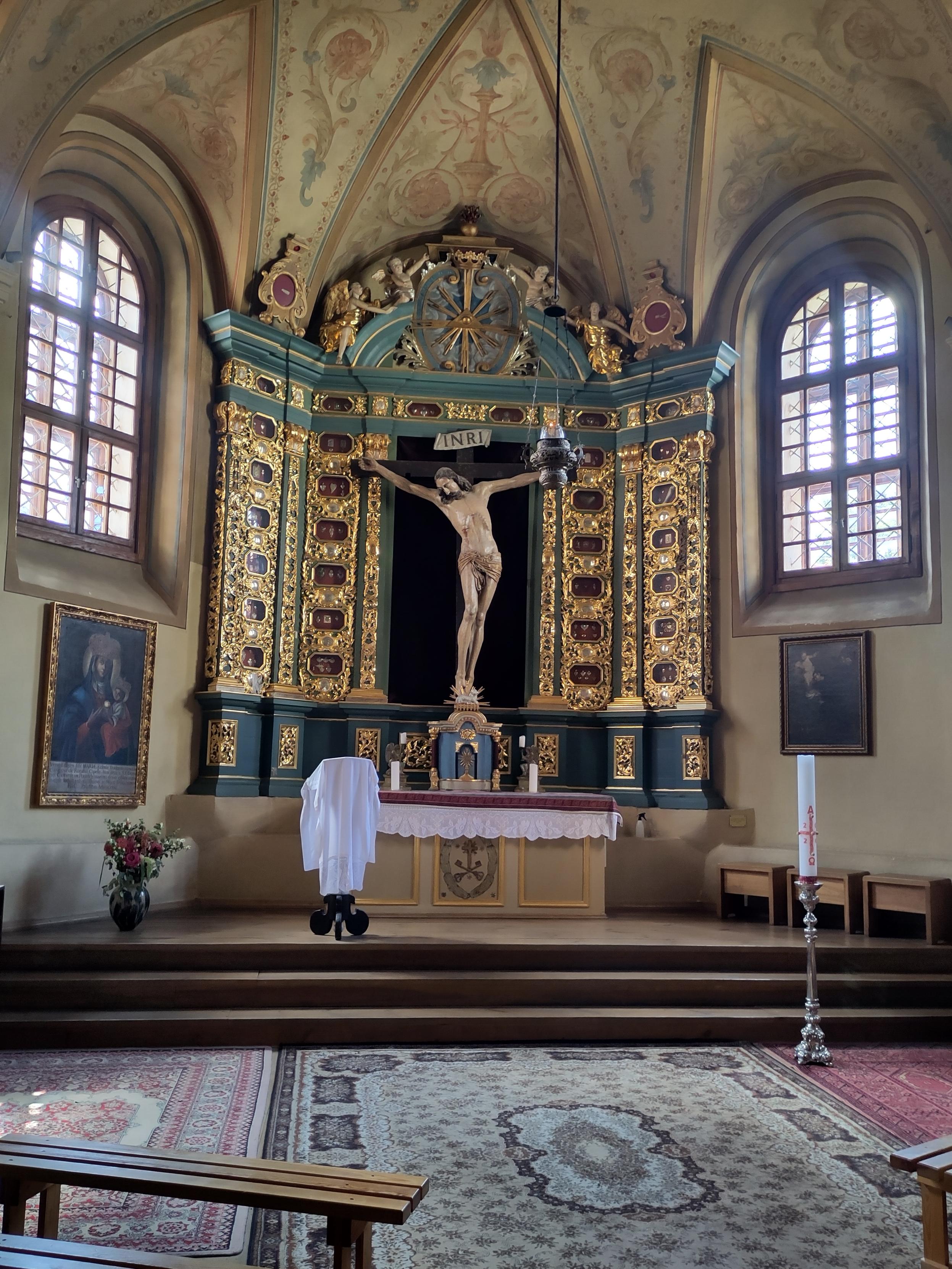 A side chapel whose altar piece is a life size crucifixion, framed with what appears to be many reliquaries. They seemed to have medals inside them. I did not approach because the lit lamp shows that there's consecrated bread in the breadbox and I didn't want to be disrespectful in case someone showed up to pray.