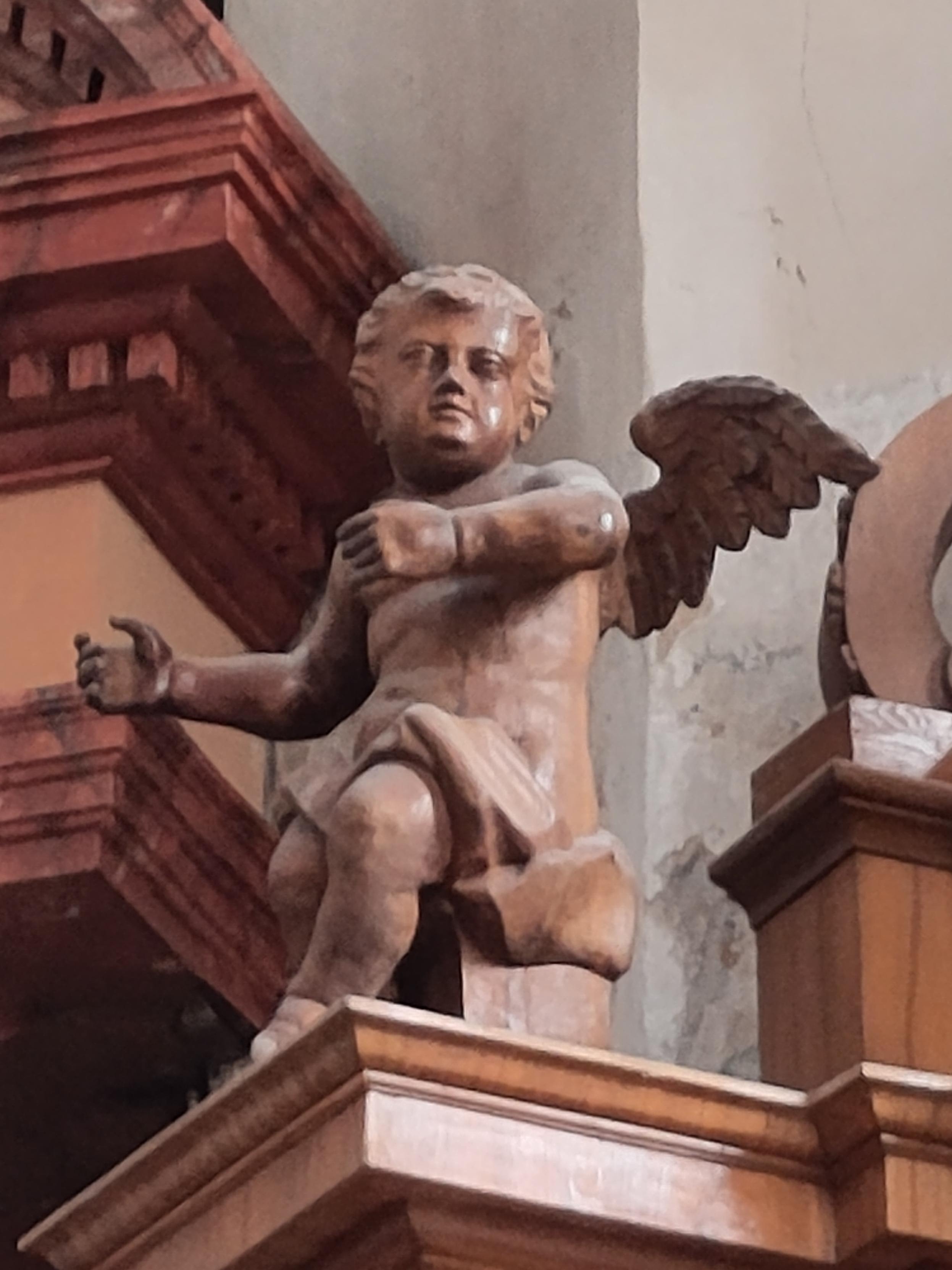 A wooden angel, which was near the front altar piece. My spouse said, "let me show you an angel who is oddly reminiscent of Trump" and I knew which one she meant …