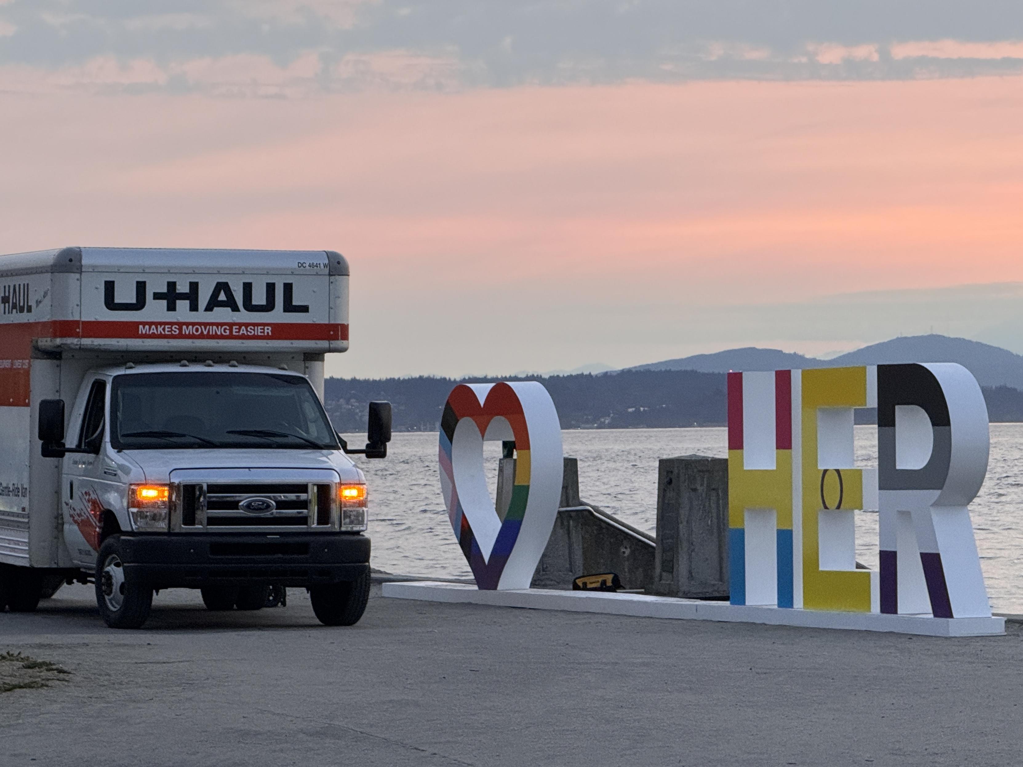 alki pride in seattle pic of a sign that was being taken down that used to say together with a heart as the o. in the pic is a uhaul that says <3   her from the remaining letters still up. the most lesbian pic ever :p